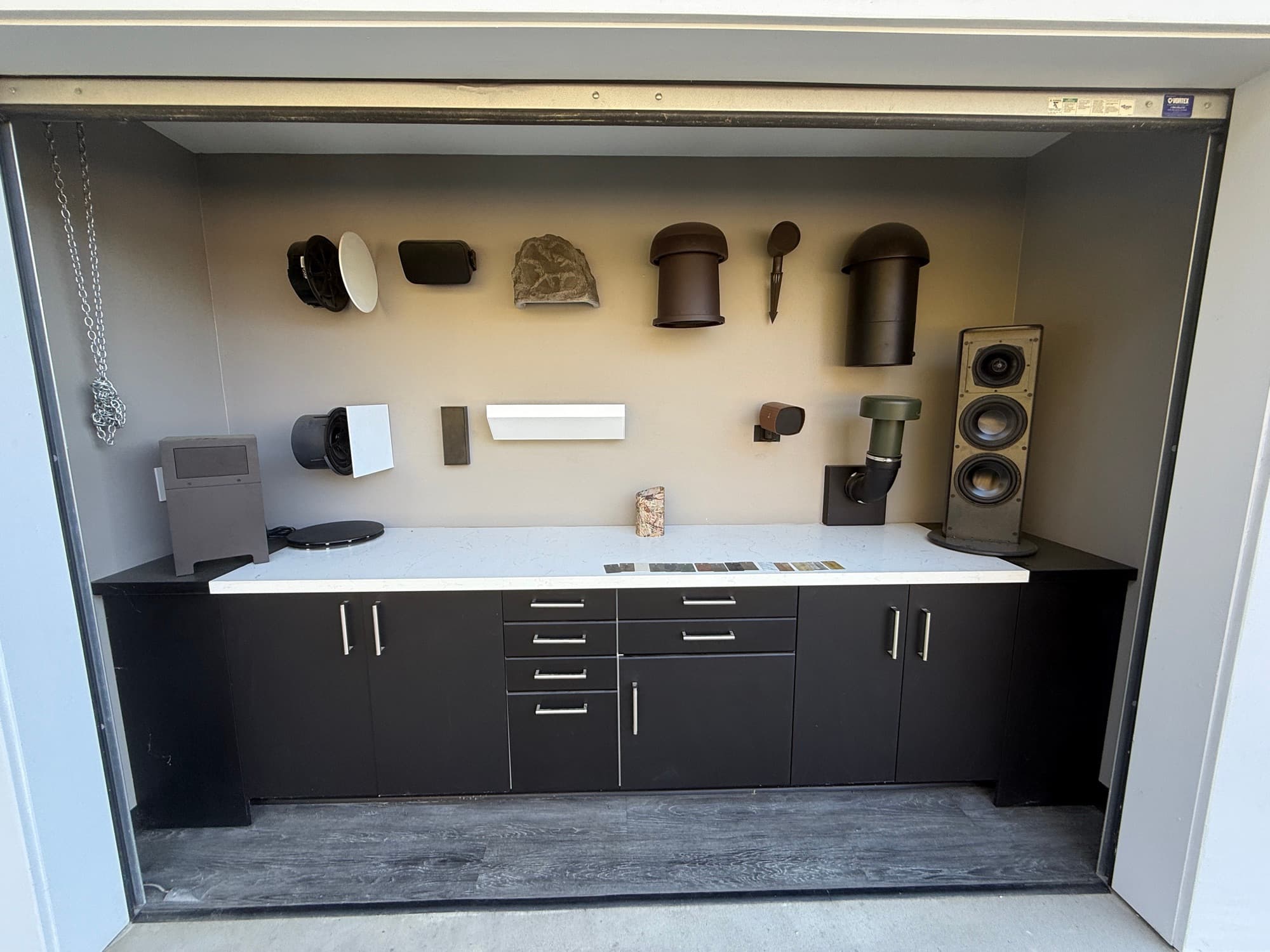 The Sonance Studio outdoor speaker display with garden, bollard, and planter speakers